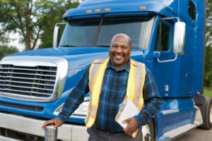 owner operator standing in front of his truck